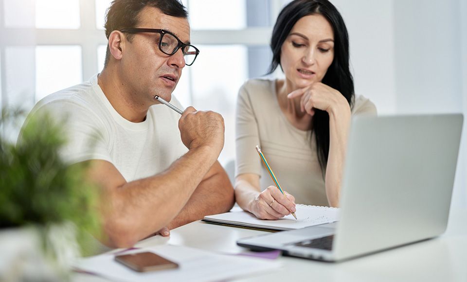 man writing on documents